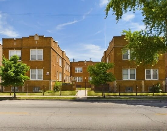Sunny courtyard framed by brick apartments