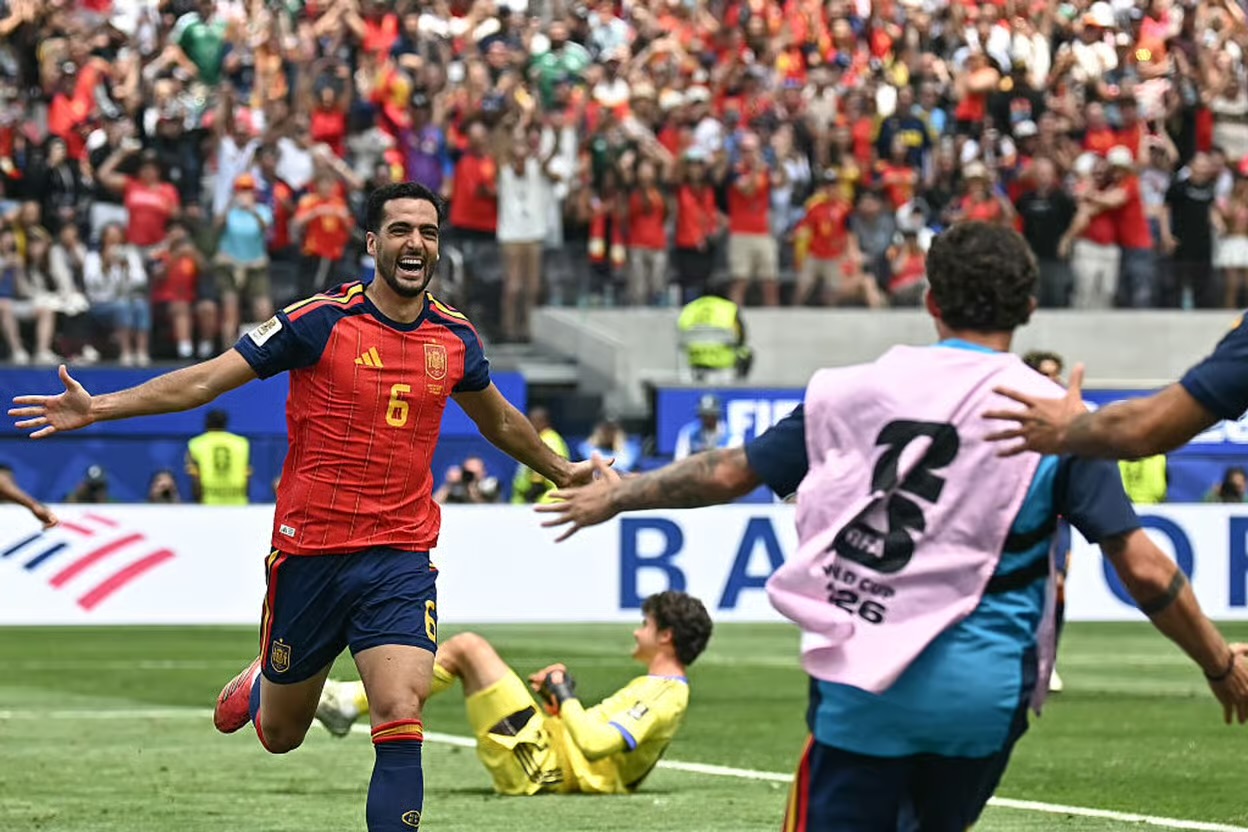 Mikel Merino and Spanish players celebrating their dramatic 2-1 victory over Belgium in the World Cup quarter-finals.