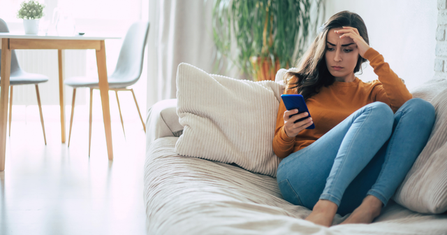Woman anxiously checking her phone