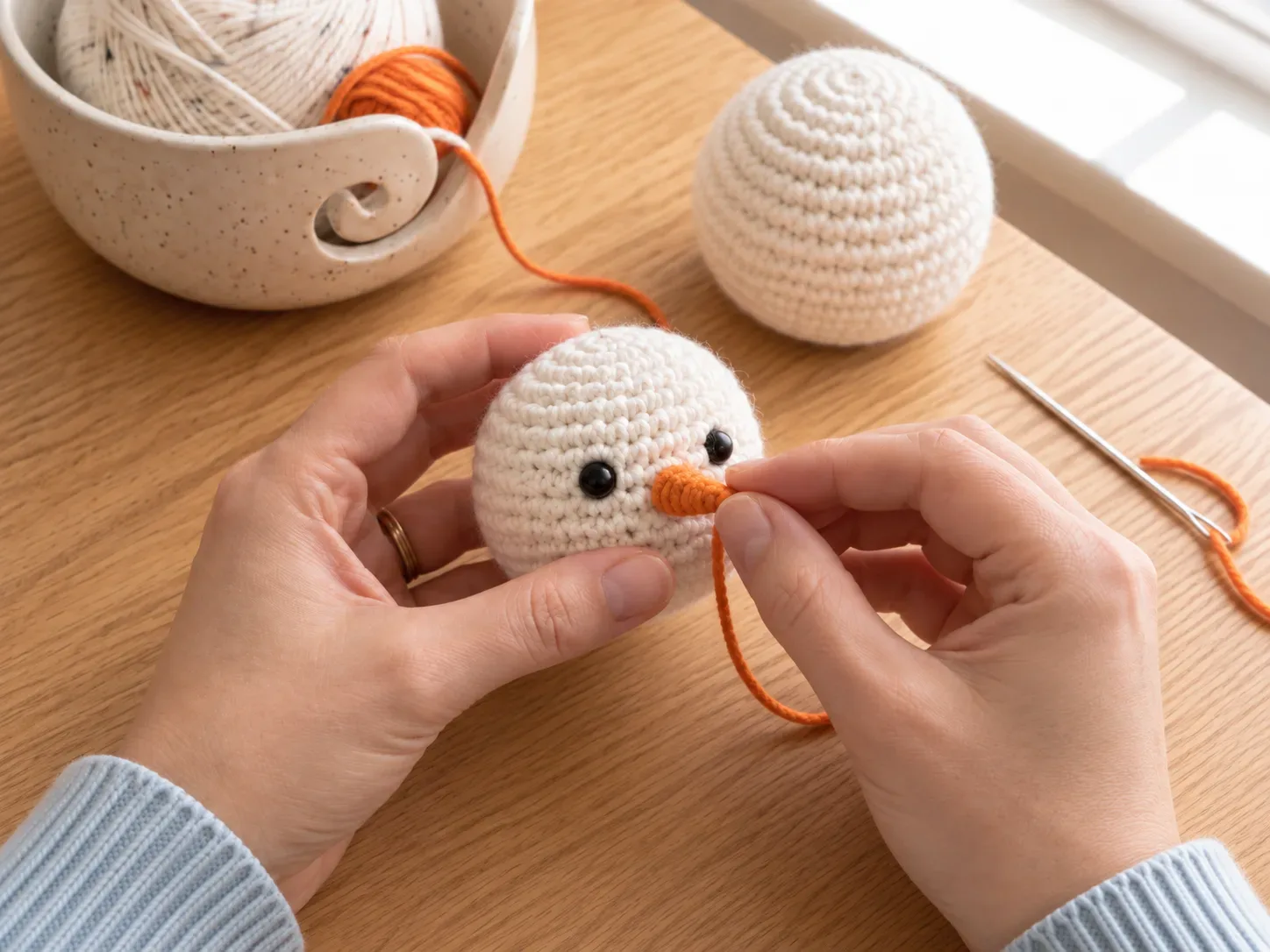 Add the face — Embroider eyes and a tiny orange carrot nose.