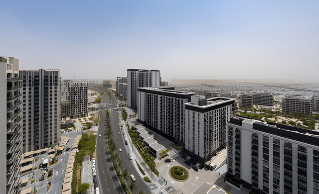 Dubai Hills Estate with modern residential buildings, green parks, and scenic roads – showcasing one of the best neighbourhoods in Dubai for expats highlighted by Destinations by LeadingRE.