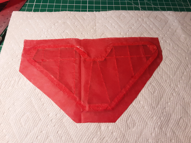 The tissue will shrink a lot and that will be the end of the slack and crease. You can only pull on it so much before it tears. Wet tissue is kind of legendary for its lack of strength.