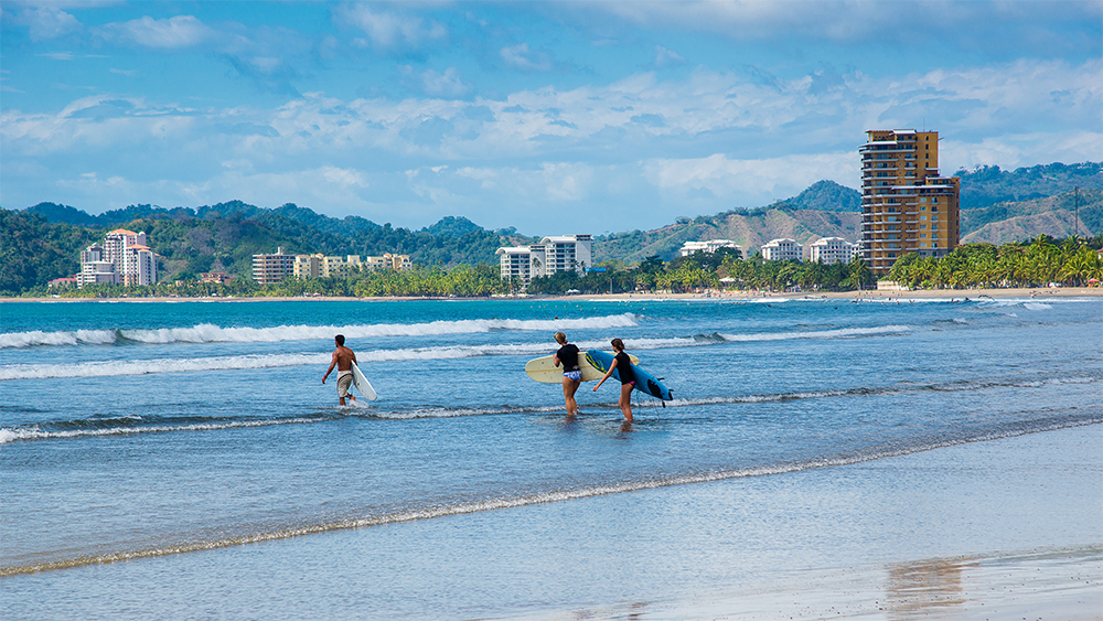 Aerial view of Jaco Beach, Costa Rica – a vibrant beachfront destination popular with surfers and international property investors seeking oceanfront living.