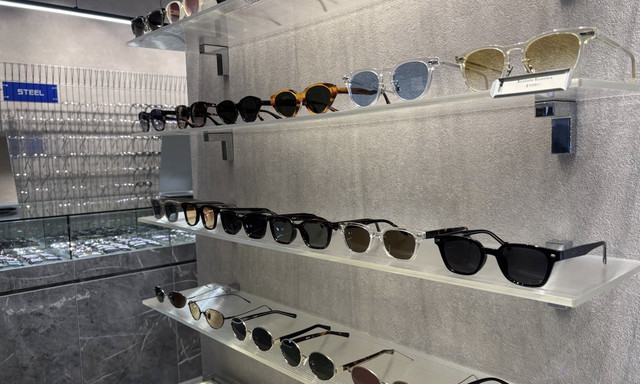 Sunglasses and optical frames displayed on shelves at Oblique Eyewear