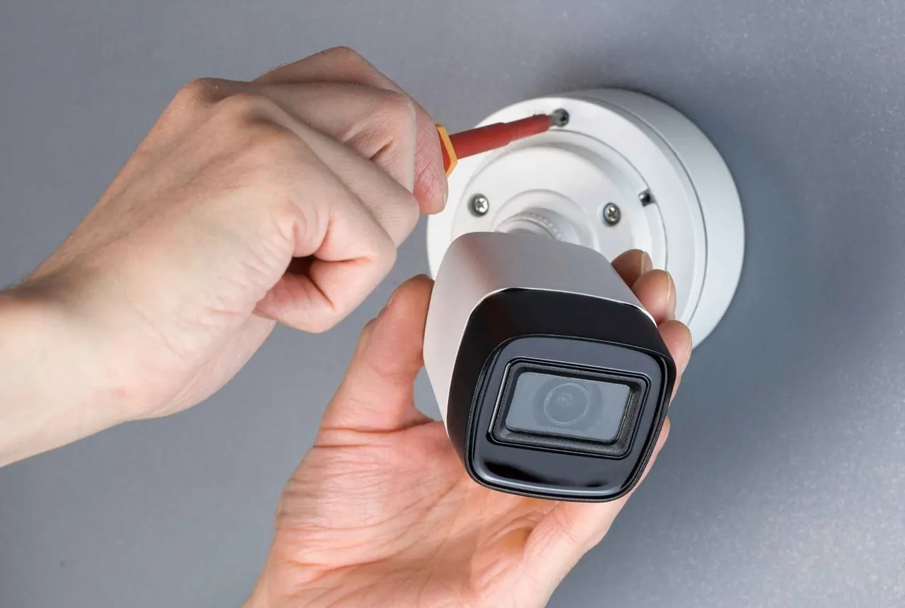 Technician installing a CCTV camera