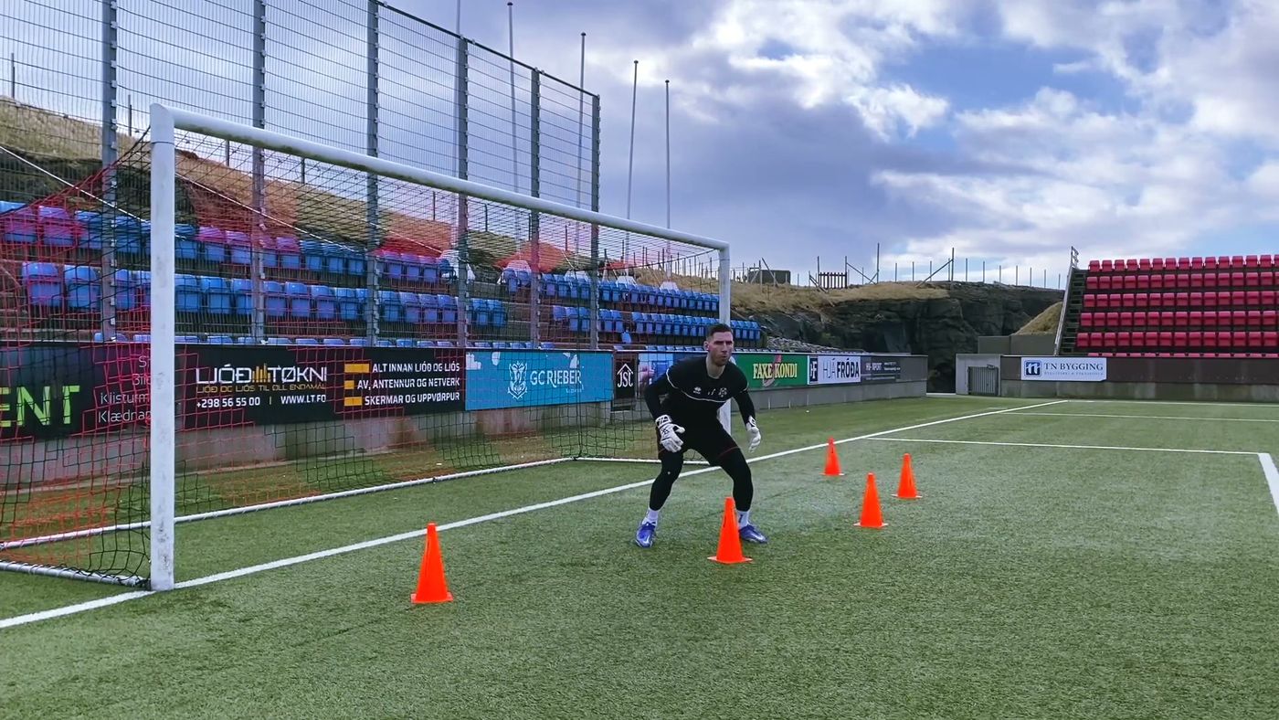 Goalkeeper shuffling sideways between orange cones across his goal