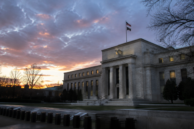Photorealistic photojournalistic image of the Federal Reserve building in Washington DC at dusk with classical columns and warm sunset light