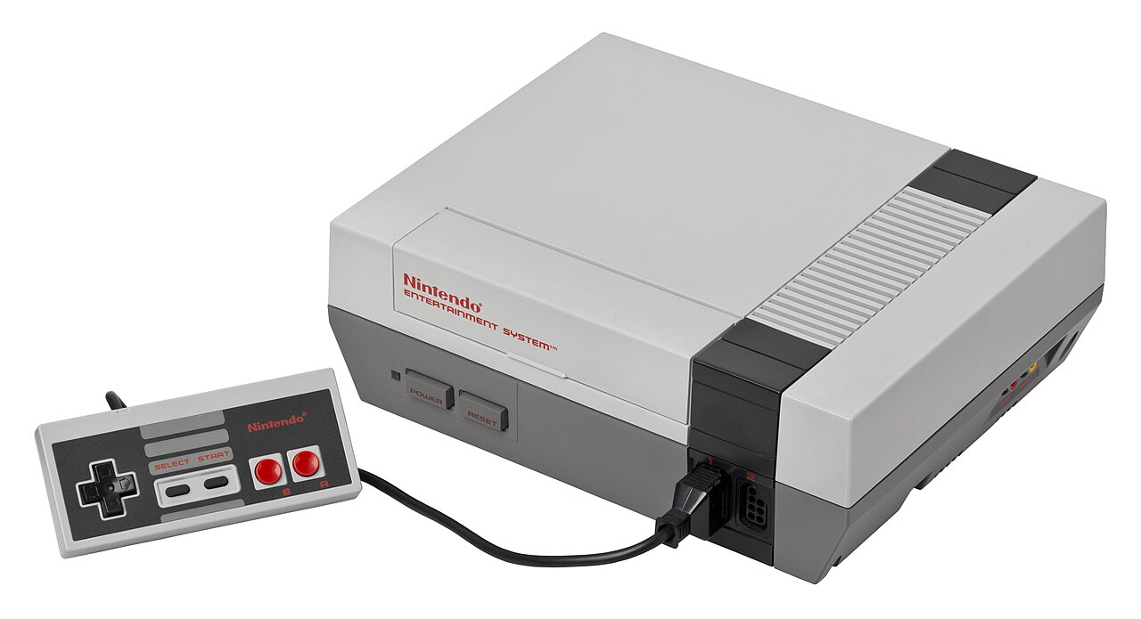 A Nintendo Entertainment System console and its rectangular controller on a white background