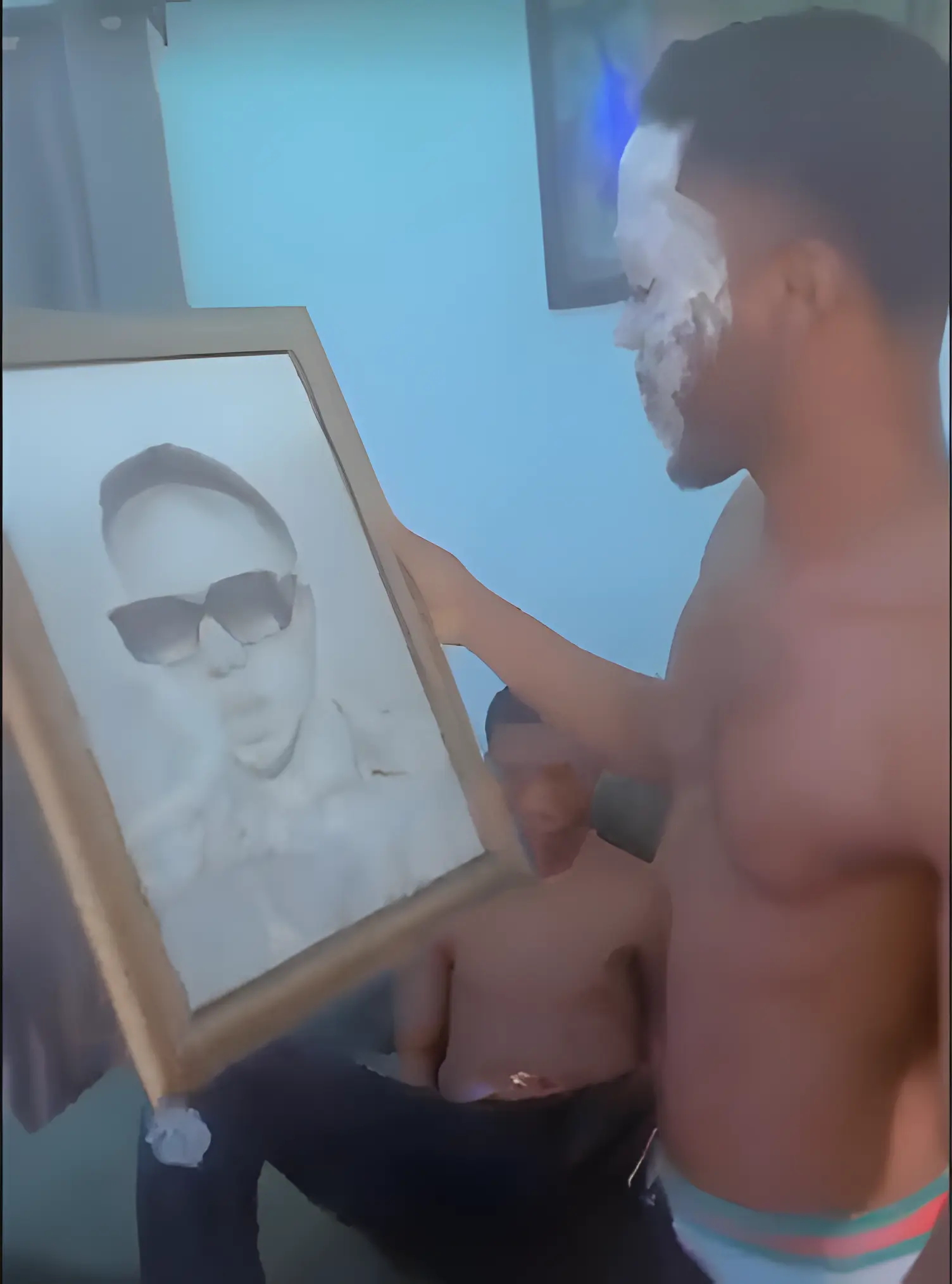 Client holding a completed pencil portrait