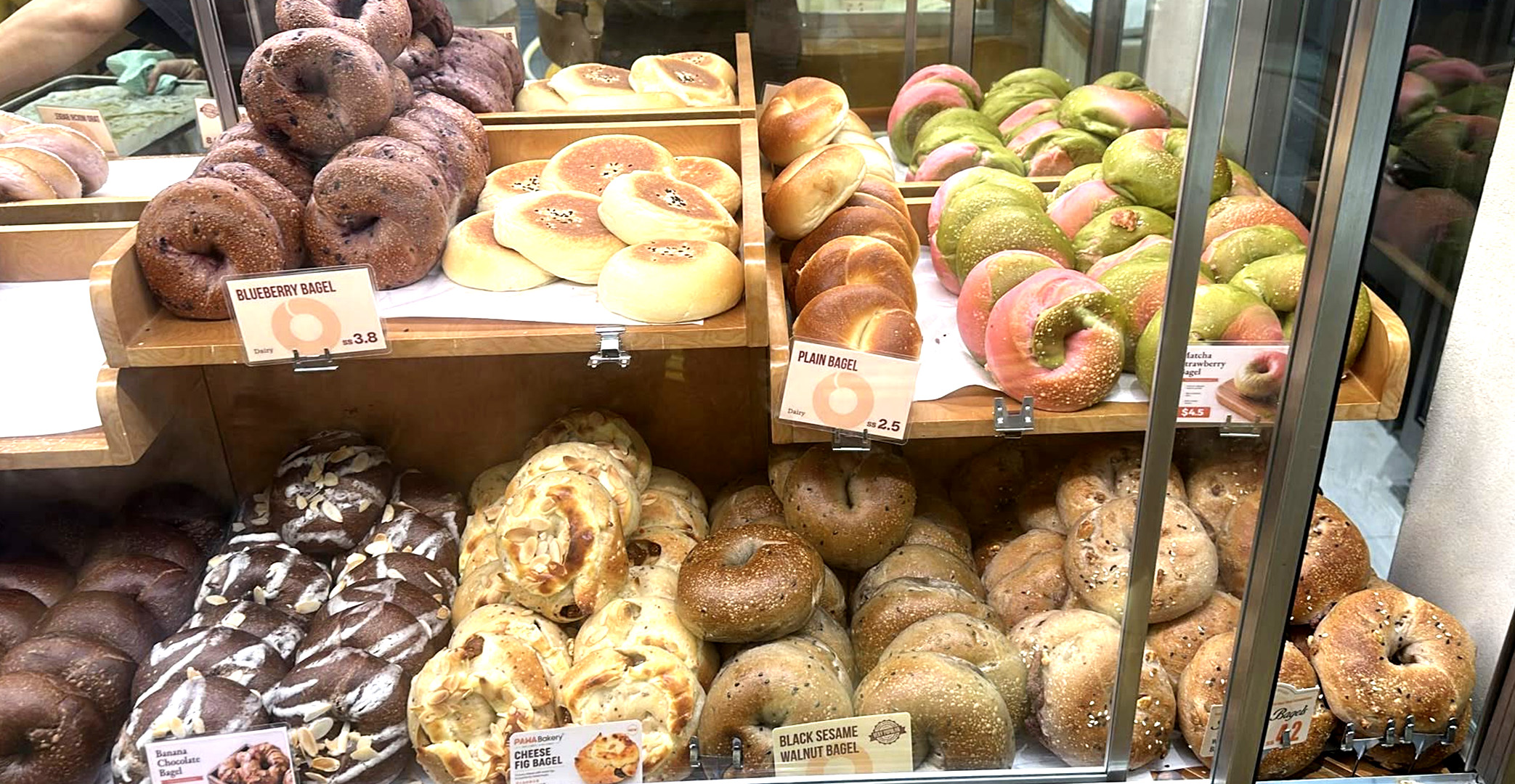 Display of fresh bagels and breads at Pawa Bakery