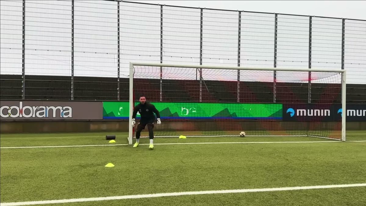 Goalkeeper set up for a collapse save with balanced stance