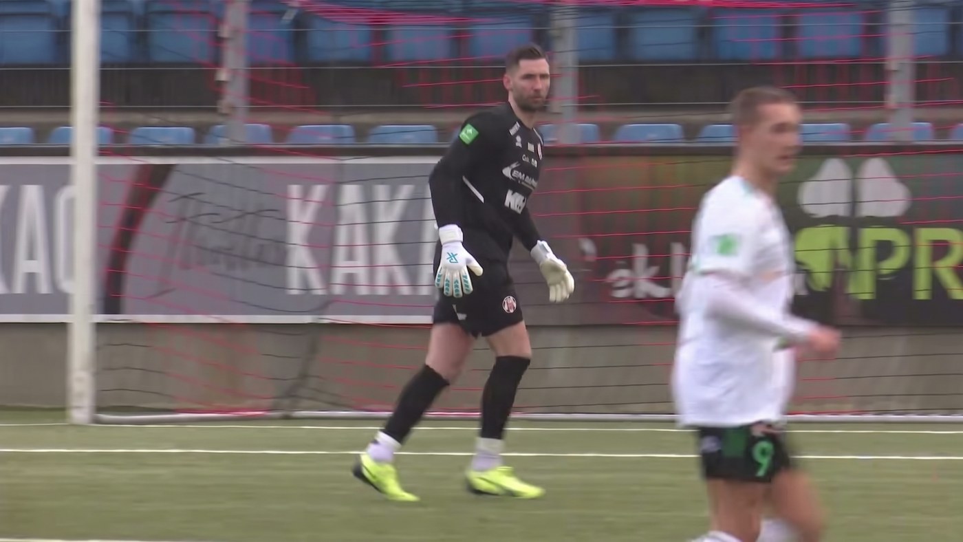 Goalkeeper in his goal shouting and pointing instructions to his defenders