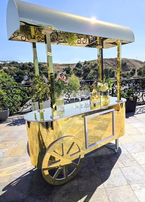 Gold Moët & Chandon branded champagne cart with floral styling