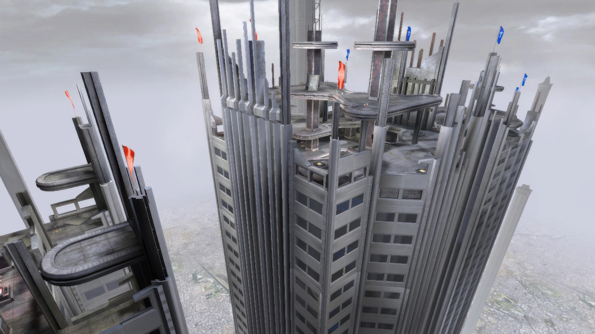 Tall futuristic buildings surrounding a rooftop arena in UT2003
