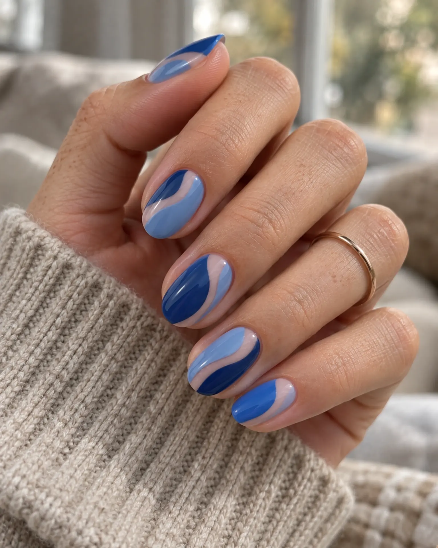 Blue Negative-Space Curve manicure inspiration for blue nail ideas