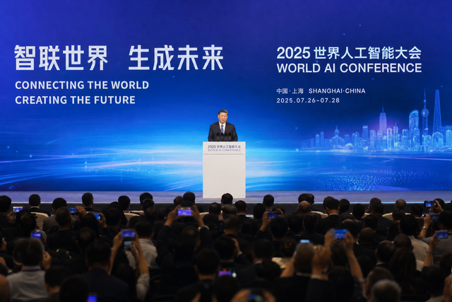 A head of state delivering a keynote address on a stage at a major artificial intelligence conference in Shanghai, large screen behind, asse
