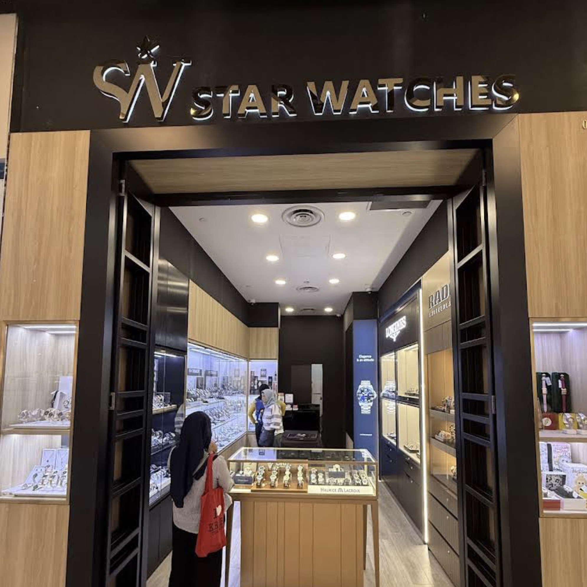 Customer trying on a watch at Star Watches PLQ Mall
