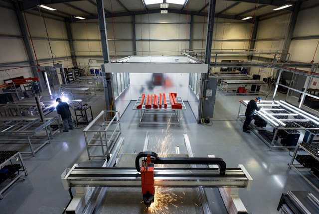 Signs.inc factory floor with CNC stations and LED assembly