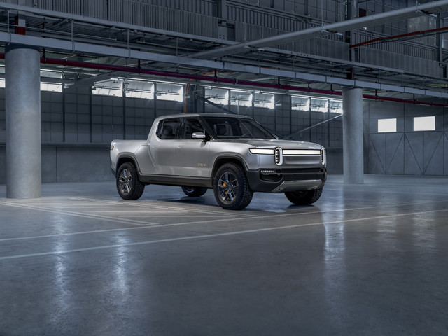 Rivian R1T — 5-ти местный полностью электрический пикап с уникальными характеристиками. Первый в своем классе электрический автомобиль, способный конкурировать с топливными аналогами и даже превосходить их по отдельным параметрам.Основу силовой установки электропикапа Rivian R1T составляют 4 электрических двигателя, каждый мощностью 147 кВт. Суммарная мощность электропривода пикапа вариативна и в зависимости от настроек может составлять: 300, 522, 562 кВт, с динамикой разгона до 100 км/ч за 4,9 — 3,2 — 3 сек соответственно.Разная мощность электрического привода соответствует разным вариантам емкости аккумуляторной батареи пикапа: 105, 135 и 180 кВт⋅ч, с запасом хода 370, 482 и 643 км.
Заряжать Rivian R1T можно при помощи зарядного устройства переменного тока мощностью 11 кВт, а также на быстрых зарядных станциях с мощностью 160 кВт.Внешне Rivian R1T похож на классический пикап, но с более современным обликом, который выдает в нем автомобиль не с топливной трансмиссией. Автомобиль обладает высоким клиренсом, вместительной грузовой площадкой с водонепроницаемой крышкой кузова, оригинальной передней и задней оптикой.Внутри Rivian R1T просторен, имеет полностью ровный пол по всему пространству салона, панорамную крышу и полностью цифровую панель приборов, которая, как и мультимедийный комплекс представлена широкоформатным дисплеем.

Особенности электрического пикапа Rivian R1T
В электропикапе есть несколько уникальных «фишек» характерных исключительно для этого автомобиля. К примеру у R1T имеет сквозной бункер расположенный за задними дверями в котором можно перевозить дополнительный багаж, требующий сохранности и полной герметичности.
Кроме того, электромобиль имеет возможность установки дополнительной съемной батареи и оснащен автономной системой вождения 3 уровня.