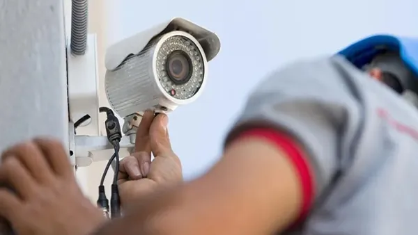 Technician servicing a CCTV camera