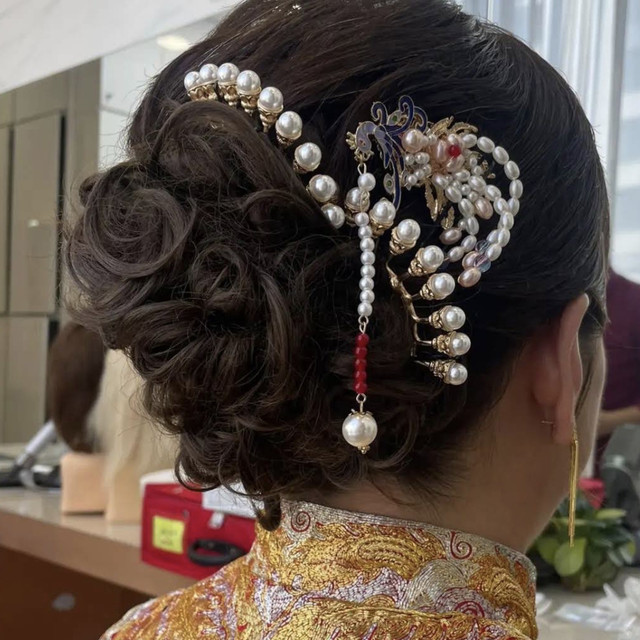 Elegant updo hairstyle with decorative accessories created at Olson Studio
