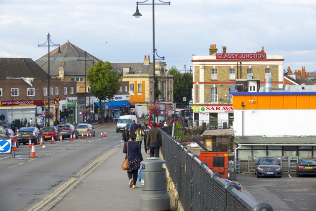 Street view of Southall, London with shops and pedestrians, showcasing the vibrant multicultural neighbourhood, ideal for international property buyers considering homes in Southall.