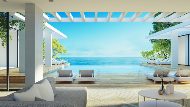 Salón moderno de lujo frente al mar con vistas panorámicas en Marbella, España – ideal para compradores internacionales que buscan viviendas elegantes en la costa.