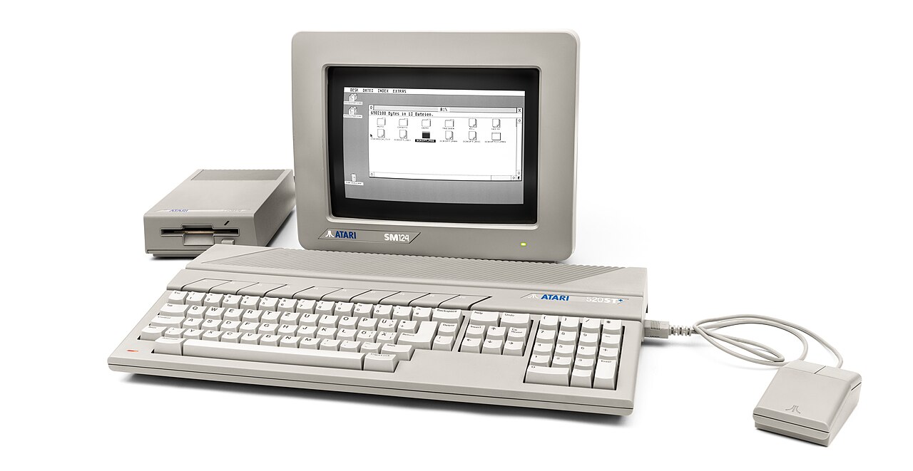 An Atari 520ST+ computer with an external floppy disk drive, mouse and SM124 monitor