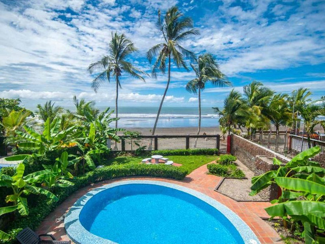 Coastal luxury home near the beach in Costa Rica featuring tropical landscaping and ocean-close living, ideal for international buyers seeking top beachside locations